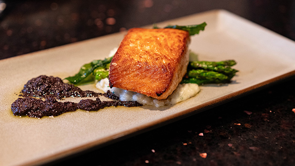 A photo of a salmon dish that is served at Edna's at the Tamarack Club